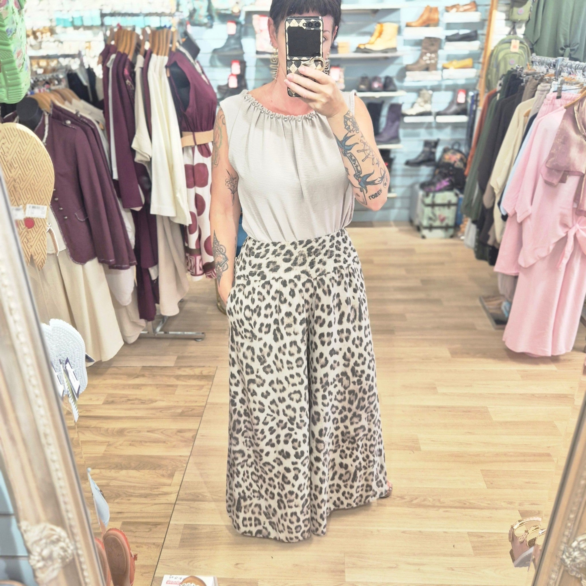 runway boutique high waisted wide leg trousers in a bold leopard animal print, styled with a neutral sleeveless top