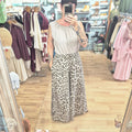 runway boutique high waisted wide leg leopard print trousers paired with a beige sleeveless top in a clothing store